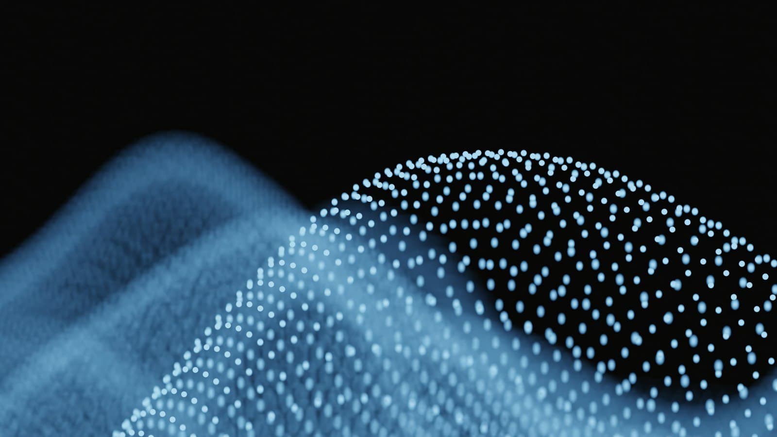 Abstract wave of glowing blue particles