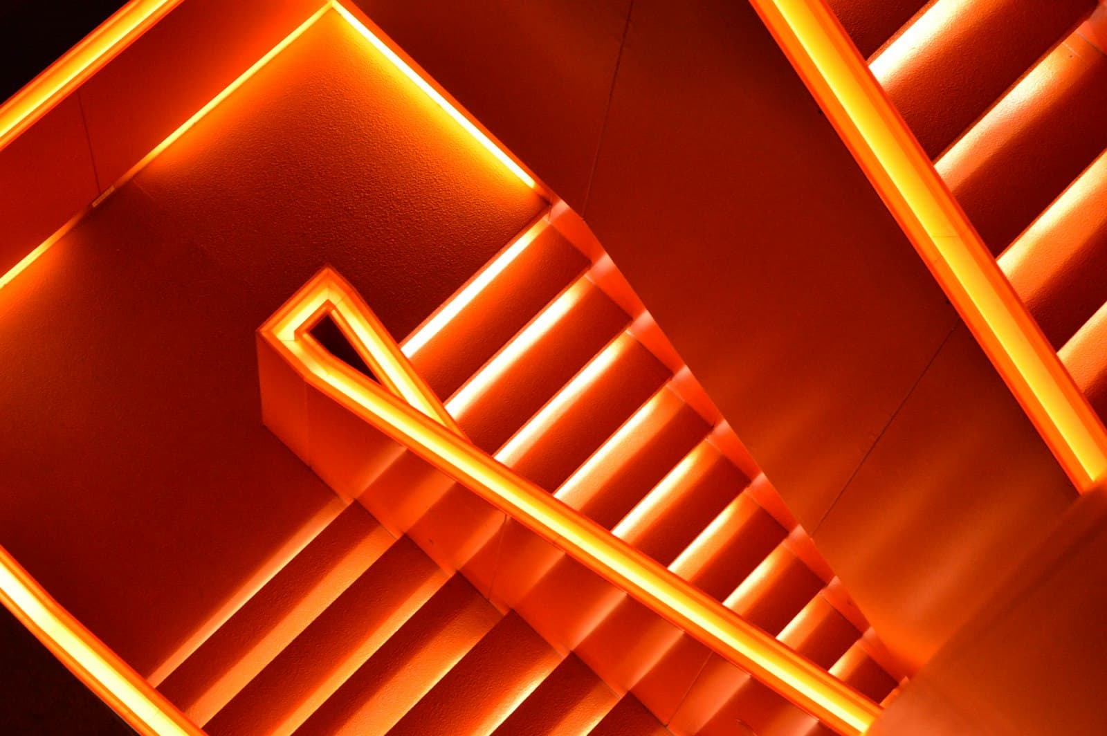 Orange-lit staircase seen from above
