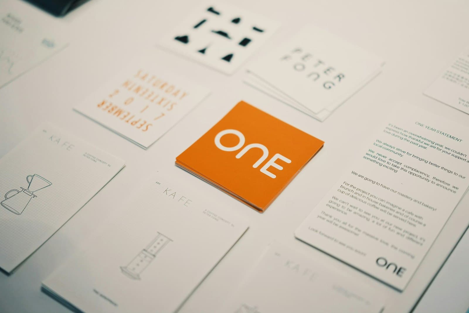 Orange brand identity cards and stationery