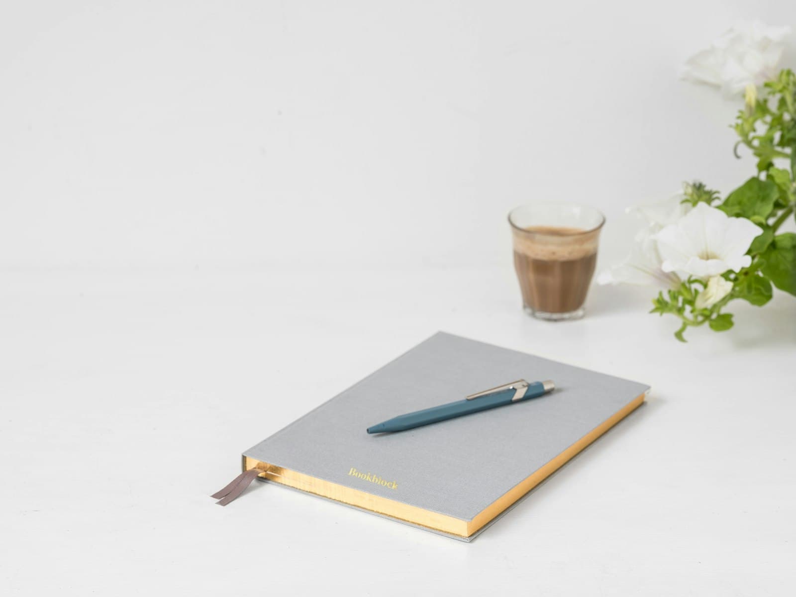 Notebook and pen on a minimal desk