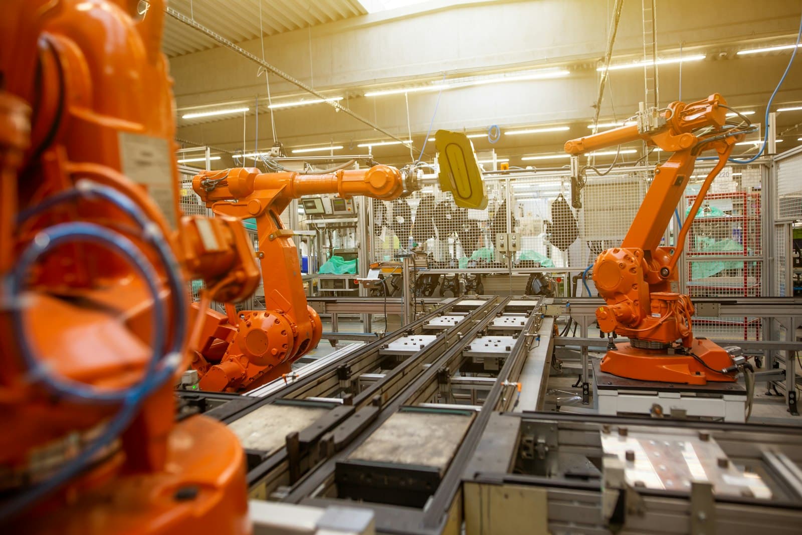 Factory floor with orange robotic arms