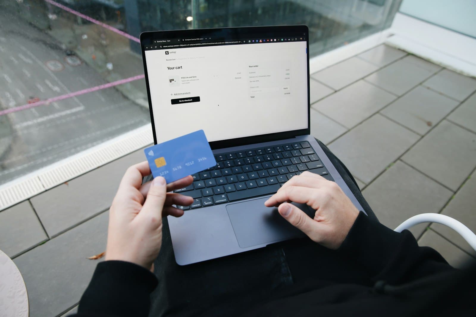 Shopper paying online with a card on a laptop