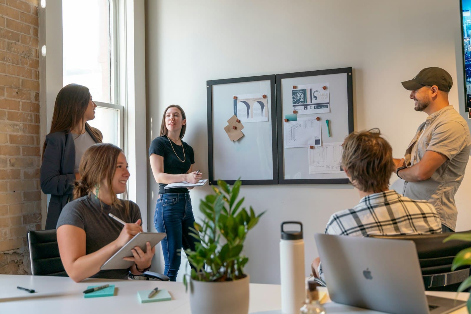 Colleagues reviewing work together in a bright studio